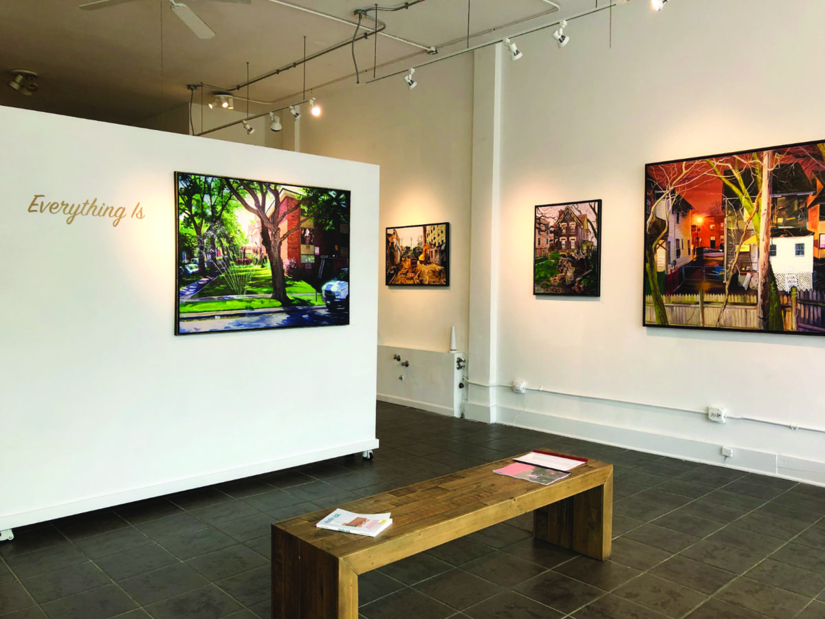 Interior of a gallery space with artwork displayed on white walls
