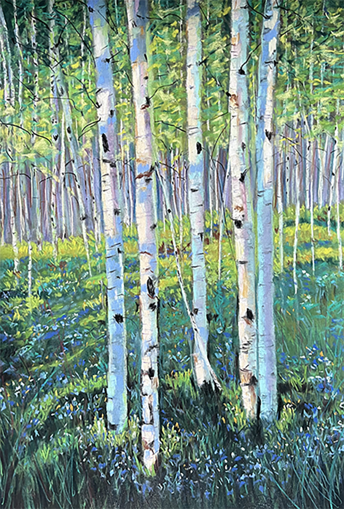 A group of five birch tree trunks are shown standing in a forested area with light blue flowers at their base. The trunks themselves are white with black spots up and down. Their treetops are not shown but the background is full of other birch trees that are shown almost top to bottom.