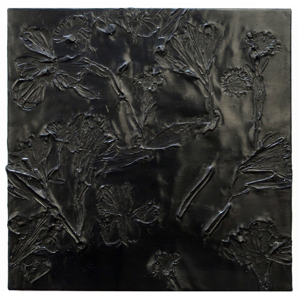 A painting with impressions of flower petals and leaves made directly into a dark, thick paint that resembles a black tar.